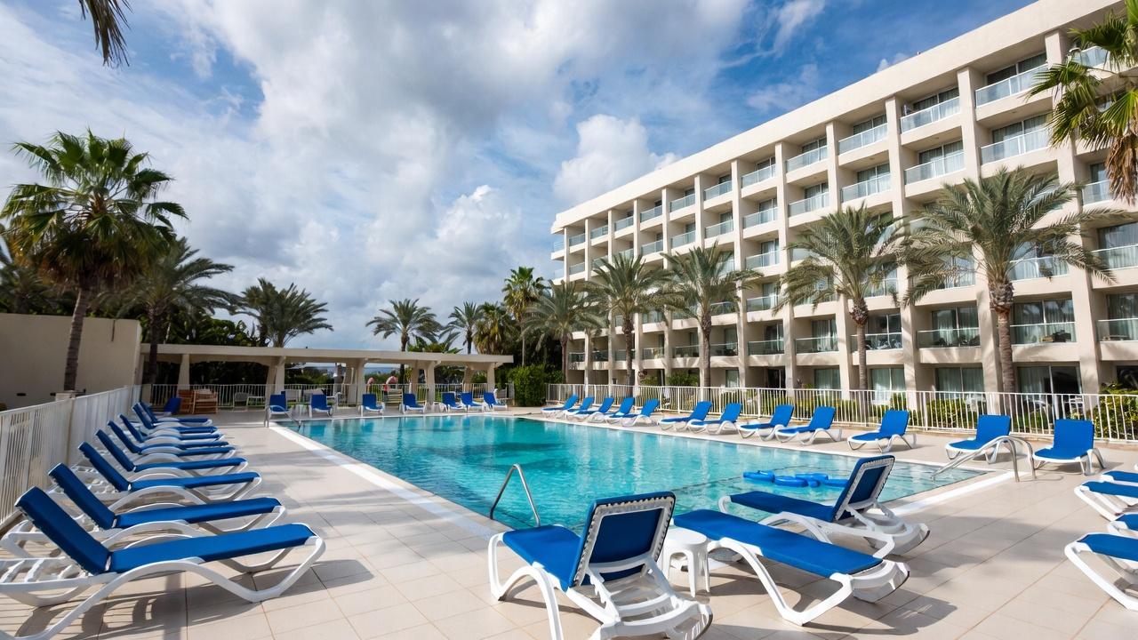 Resort-grade infinity pool deck with cabanas at sunset